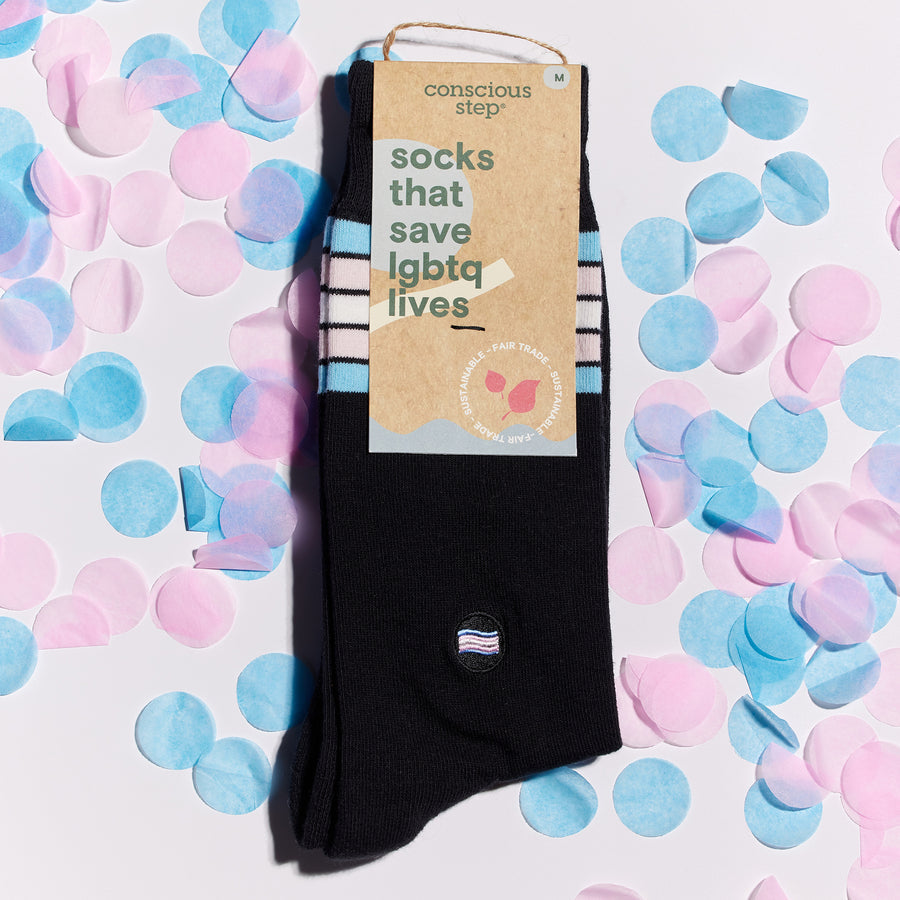 a pair of black socks in cardboard packaging that reads