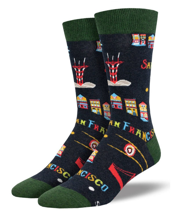 Foot forms wear a pair of dark gray crew socks featuring famous San Francisco landmarks like the Golden Gate Bridge, Sutro Tower & the Painted Ladies.