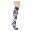 A photograph of a black and white tie-dye over the knee sock shown on a leg form.