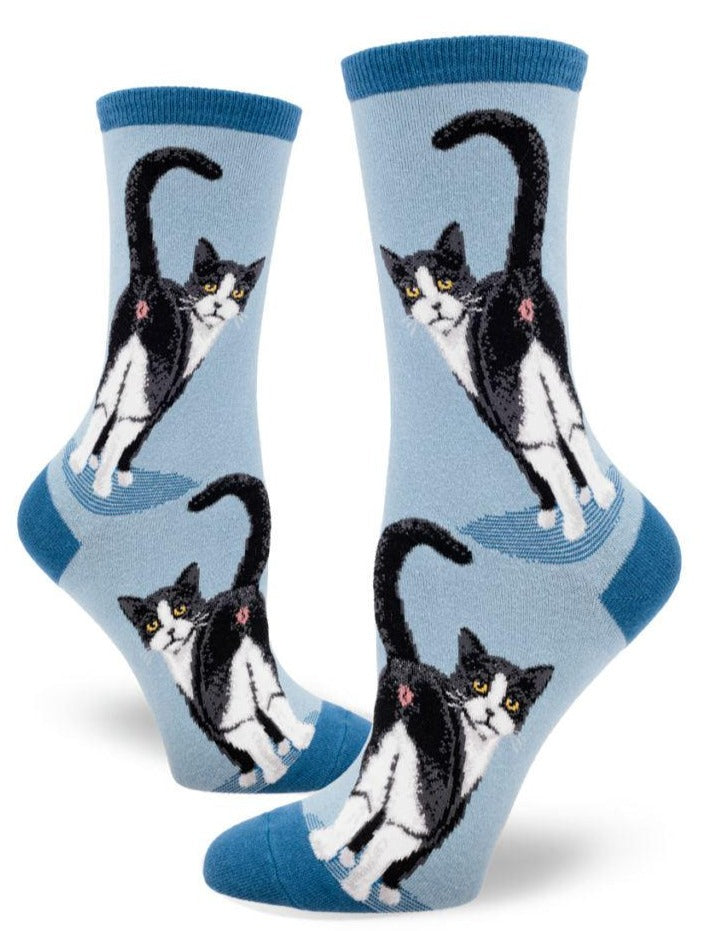 a light blue pair of socks featuring two tuxedo cats showing off their butt holes with a darker blue toe, heel and cuff