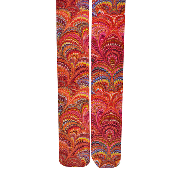 A pair of tights with a psychedelic 70's print of swirled red, pink, orange, yellow and blue, shown flat lay.