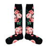 Flatlay image of black knee-high socks featuring pink roses