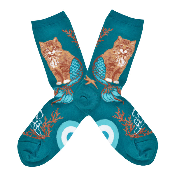Turquoise socks with an image of a cat with a mermaid tail surrounded by coral and a sea star, photographed flat lay.