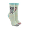 Shown on a leg form, these cream cotton unisex crew socks with a contrasting gray and pink toe, blue cuff, and blue thin stripes by the brand Out of Print feature a gray elephant on one leg and a pink pig on the other leg.