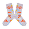 Shown in a flatlay, a pair of women's Yellow Owl Workshop cotton and nylon crew socks in lilac. These socks feature iconic San Francisco imagery like the golden gate bridge, peace signs, VW vans, seagull signage, and flower power.