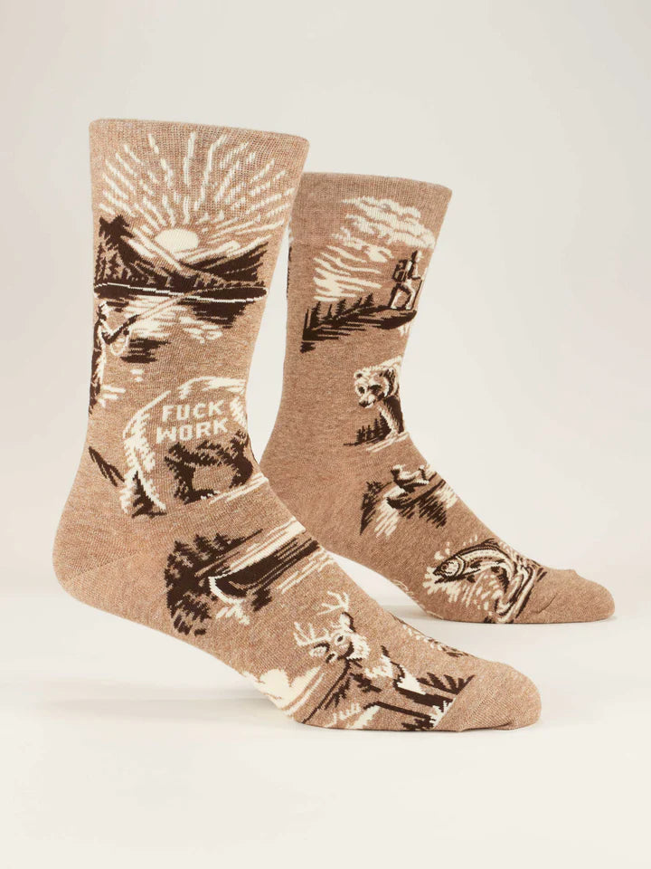 Footforms wearing light brown crew socks with designs of a fisherman at a mountain lake sunset, deer, canoes, and a bear with text that reads 