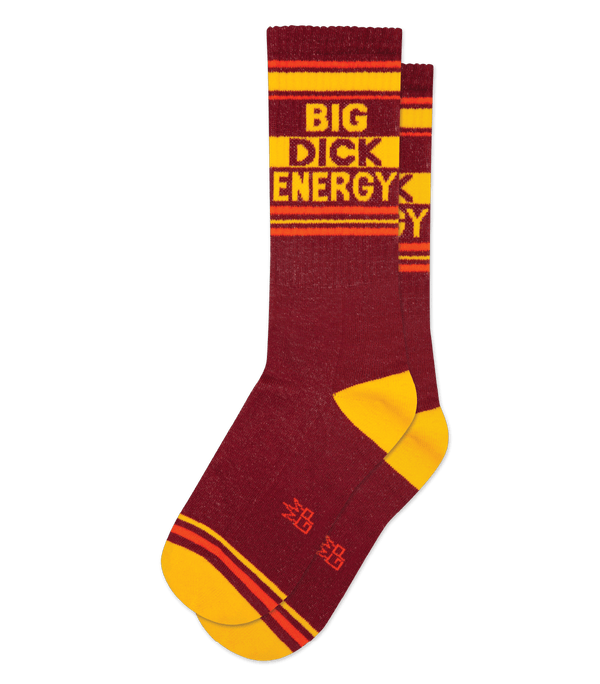 burgundy socks laid flat with a yellow toe and heel and orange stripes with bold text that reads BIG DICK ENERGY