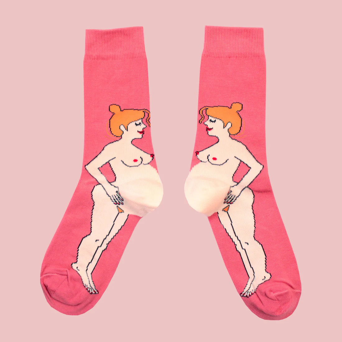 Pink socks with illustrations of a redheaded pregnant white woman on a pink background
