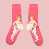 Pink socks with illustrations of a redheaded pregnant white woman on a pink background