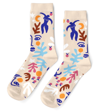 a pair of light beige socks featuring a pattern inspired by Matisse paintings, with abstract blue feminine bodies, seaweed shapes in blue, ink and brown, yellow crescent moons, and ink blue faces