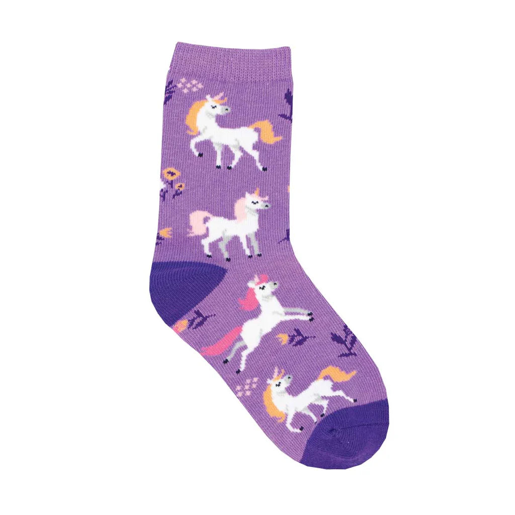 Purple crew sock shown in flatlay featuring prancing white unicorns with pink manes and pink & purple flowers