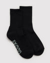A pair of black crew socks with the brand name 'BAGGU' printed in light gray on the sole, displayed against a light gray background.