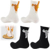 Side view of 2 pairs of socks featuring cats with pompom balls, one black with gray and one cream with orange