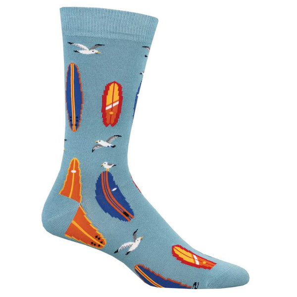 Blue sock on footform featuring red, blue and orange surfboards and seagulls flying and perching on them