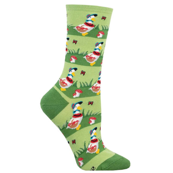 Foot form wears a green crew sock with dark green toe and heel and scenes of a goose in a blue bonnet and red shawl foraging for mushrooms with a butterfly