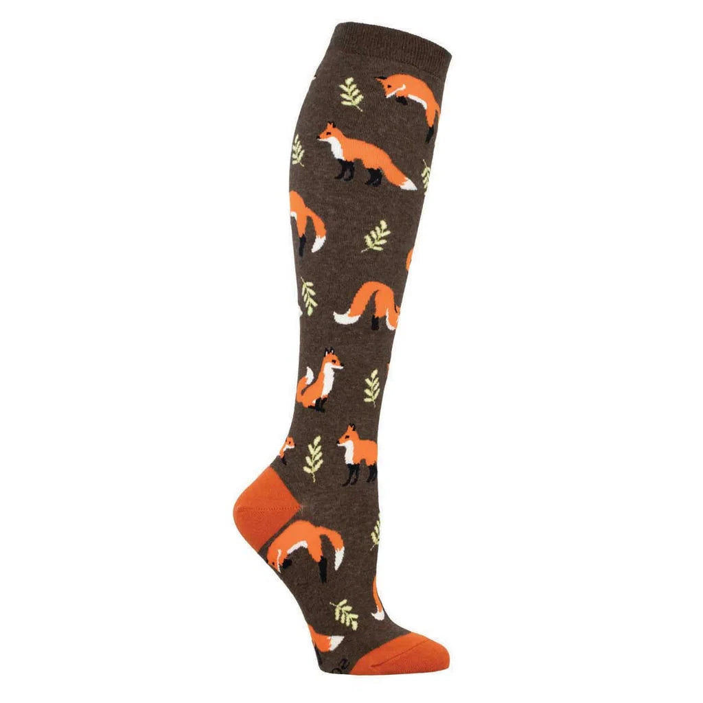 Foot form wears a brown knee high sock with orange heel & toe featuring green ferns and foxes in various poses