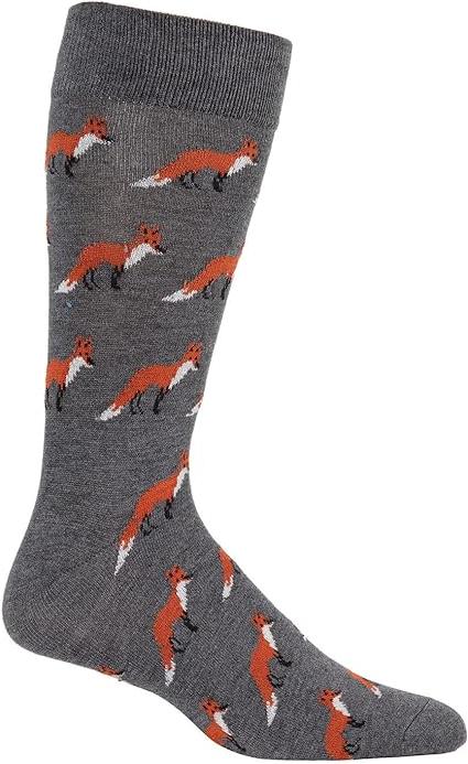 A charcoal-colored  crew sock on a foot form sits on a white background. A tessellated pattern of standing orange-and-white foxes covers the entirety of the sock.