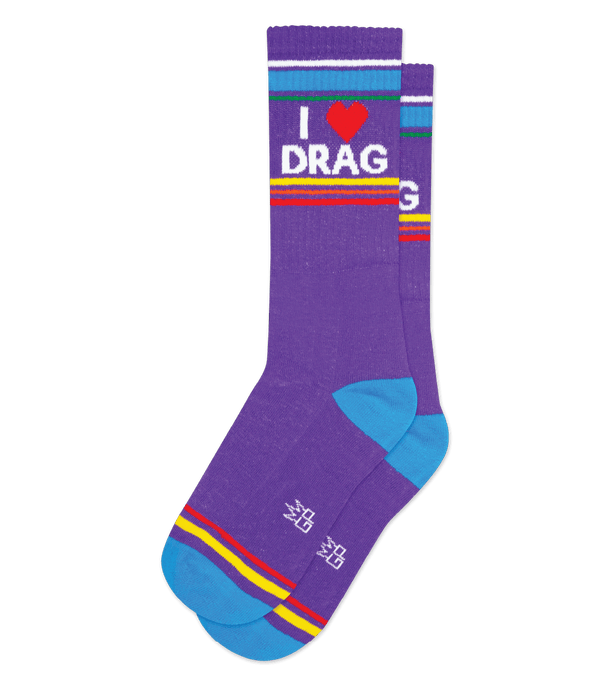 a pair of purple socks laid flat featuring a blue toe and heel, rainbow stripes near the cuff and bold white text that reads I HEART DRAG