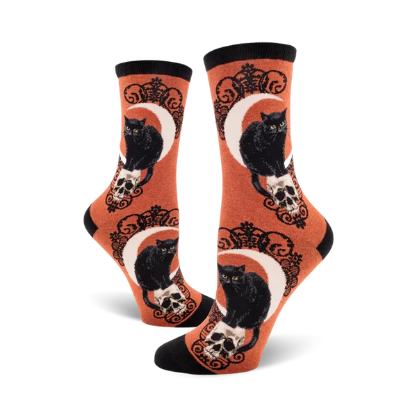 Pair of socks with black cat, skull and moon design on an orange background