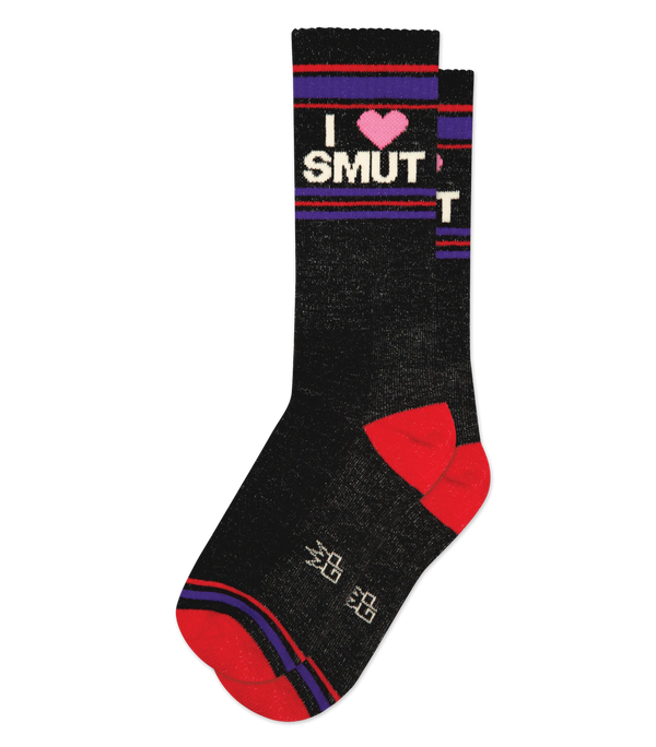 In flatlay, pair of black crew socks with red heel, red & purple stripe patterns at toe and leg, & beige text that reads "I 💗 SMUT"