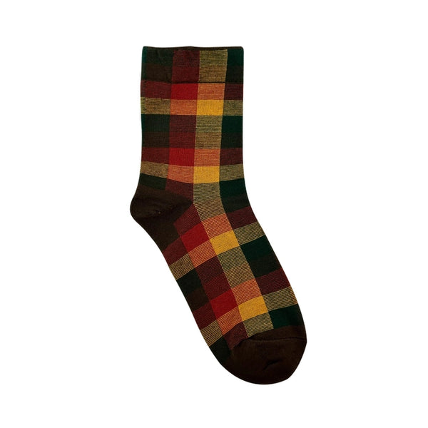 Red, brown and yellow plaid patterned sock on a white background