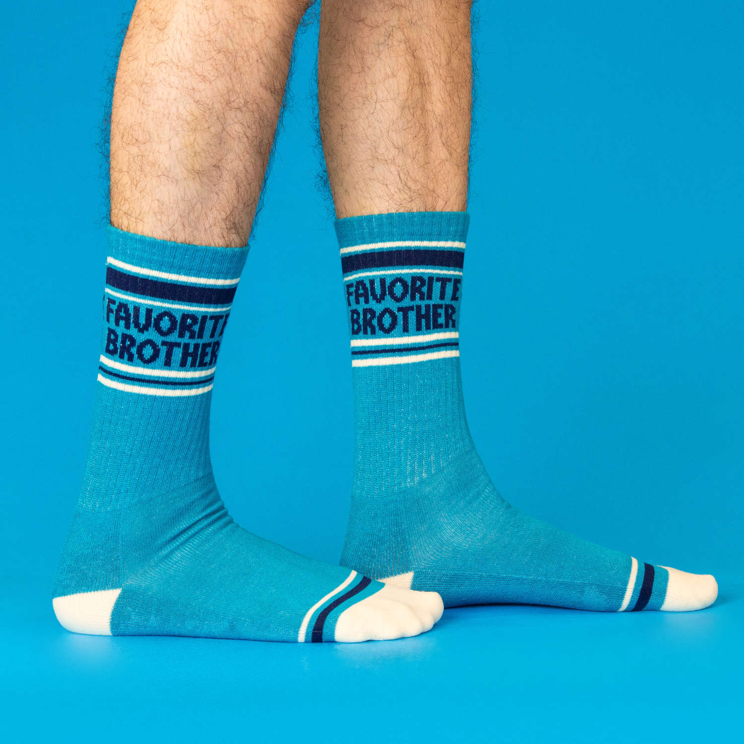 Model wears blue socks with 'Favorite Brother' text on a blue background