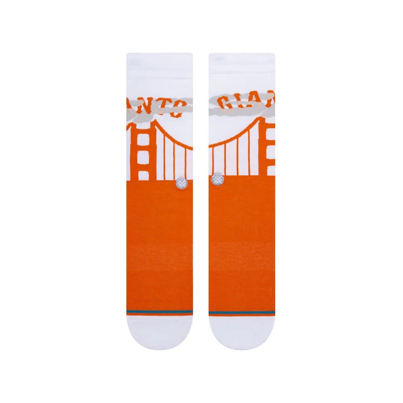 Two socks shown in flatlay from the front with white leg, heel & toe and orange feet. The leg sports gray fog, an orange depiction of the Golden Gate Bridge, and orange text that reads 