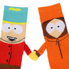 Close-up of 2 socks in flatlay, one made to look like Cartman and the other Kenny, with 3D arms and magnetic hands
