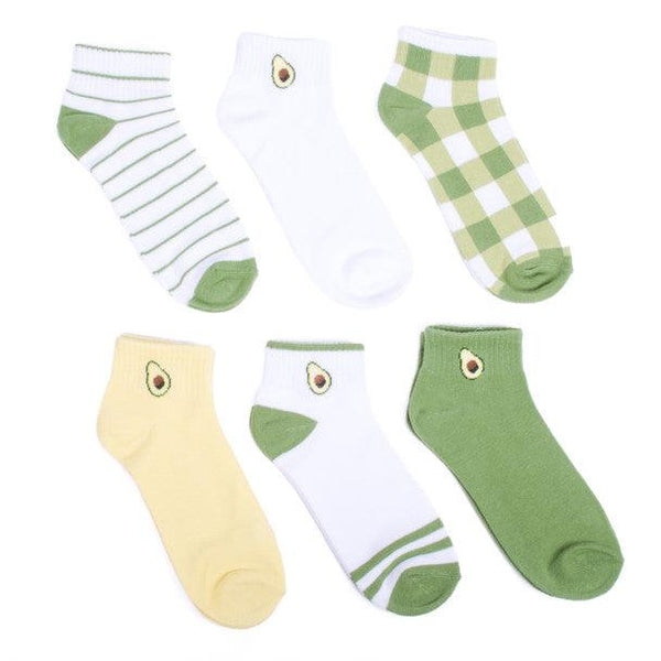 A white background holds six pairs of quarter-crew socks in flatlay: green, yellow and white plaid, solid white with half an avocado on the ankle, white with green stripes, green with an avocado on the ankle, white with green bands around the toe and ankle and an avocado on the ankle, and solid yellow with an avocado on the ankle