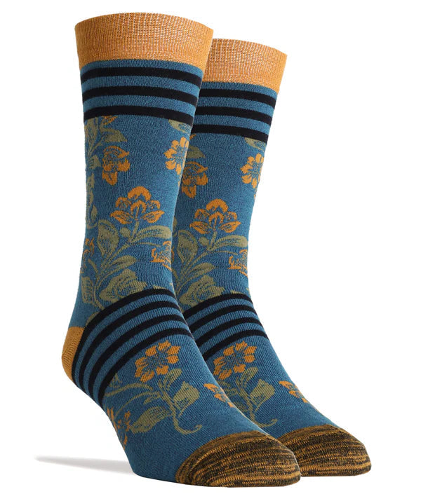 Foot forms wear a pair of blue socks with gold and green floral patterns