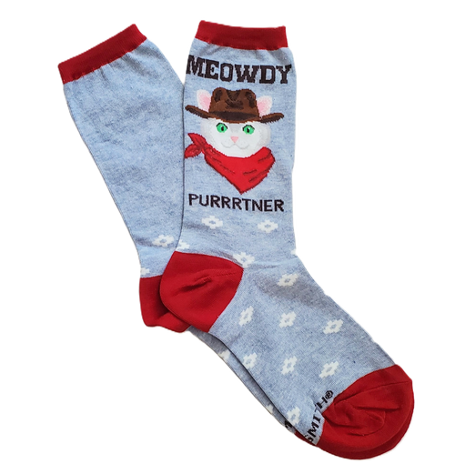 Blue socks with red trim in flatlay that feature a cowboy cat and text that reads "MEOWDY PURRRTNER"