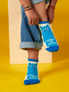 Person dons cream-colored ankle socks featuring a blue cat and text that reads "CUDDLE ME BITCH"