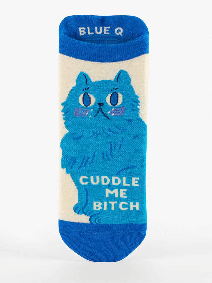 Flatlay image of a cream-colored ankle sock featuring a blue cat and text that reads 