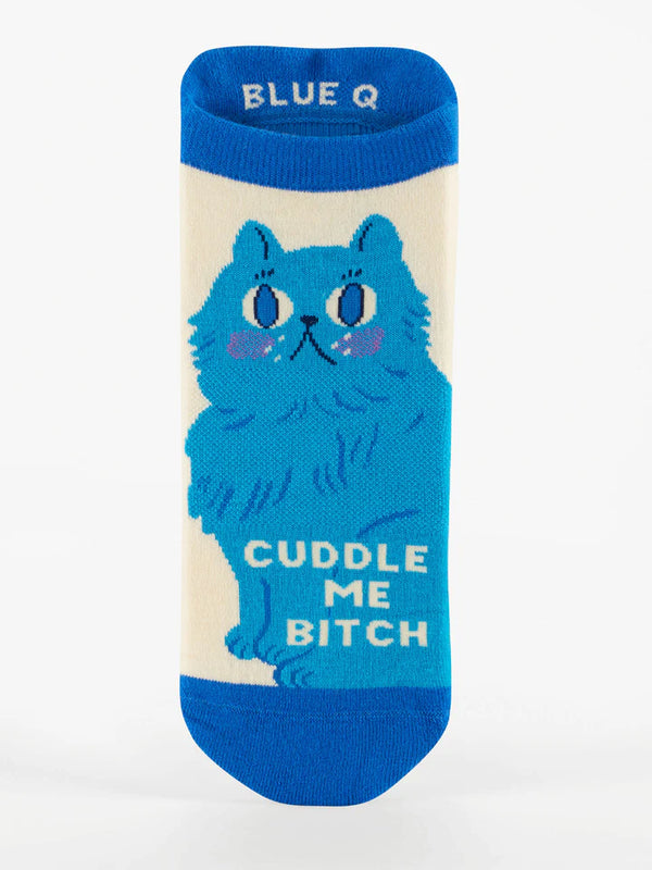 Flatlay image of a cream-colored ankle sock featuring a blue cat and text that reads "CUDDLE ME BITCH"