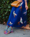 Model demonstrates how to style vine and floral-patterned sheer socks with colorful shoes, dress & accessories