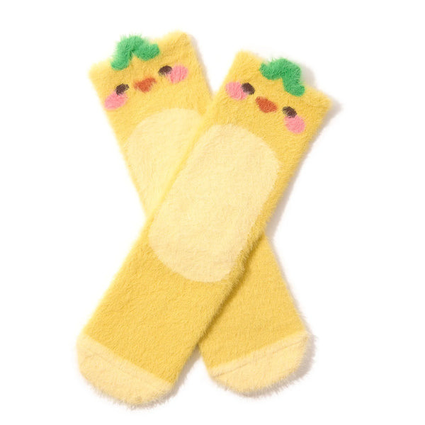 2 fuzzy yellow crew socks fashioned to look like ducklings with leaves on their heads are shown against a white background.