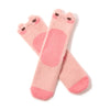 A pair of pink fuzzy crew socks with blushing frog faces at the top is shown in flatlay on a white background.