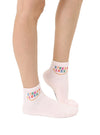Model shown from knees down wears peach ankle socks with a smiley and STRESS LESS in rainbow text on them