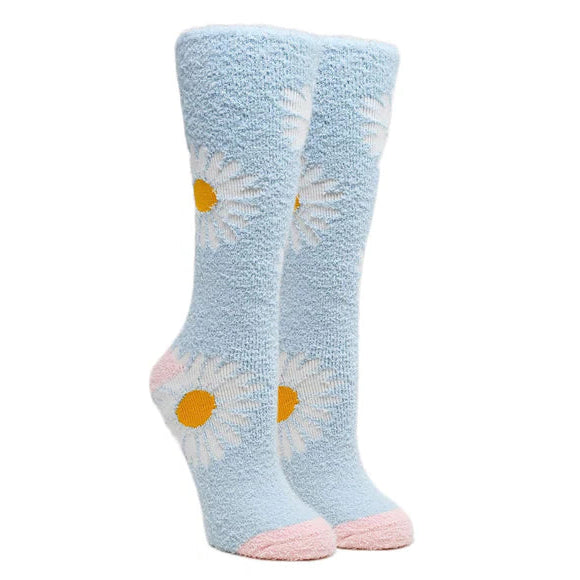 Two leg forms wear fuzzy light blue socks with pink heel and toe featuring large white daisies throughout