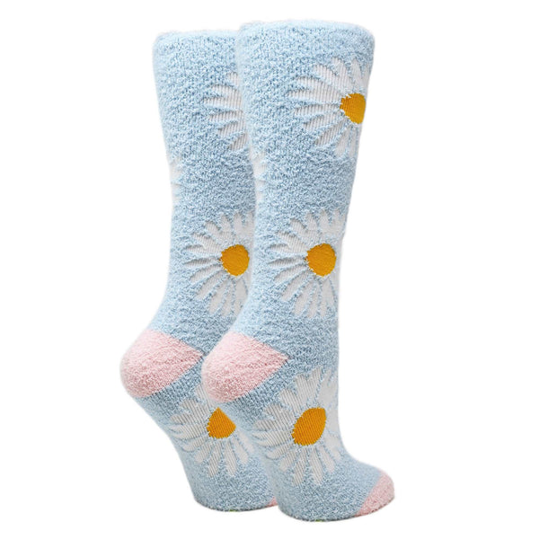 Shown from the back, two leg forms wear fuzzy light blue socks with pink heel and toe featuring large white daisies throughout
