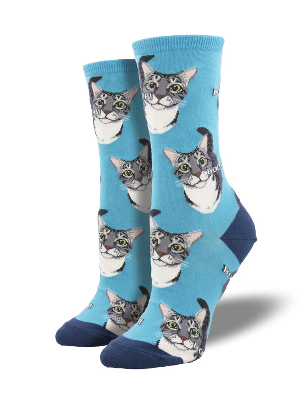 On leg forms a pair of blue crew socks with a gray and white cat's face all over. The word "BOOP" spelled out all over the socks.