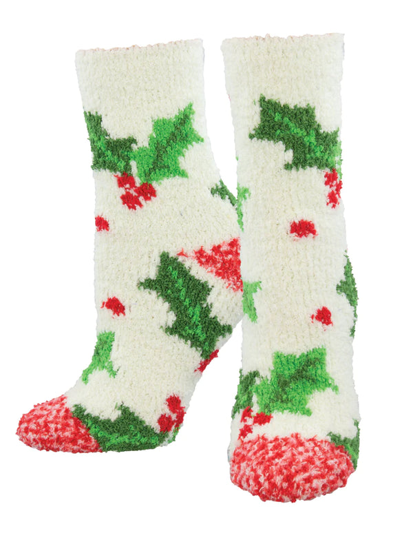 Shown on leg forms, a pair of women's fuzzy crew socks in cream in with a red toe and a festive holly motif all over the sock.