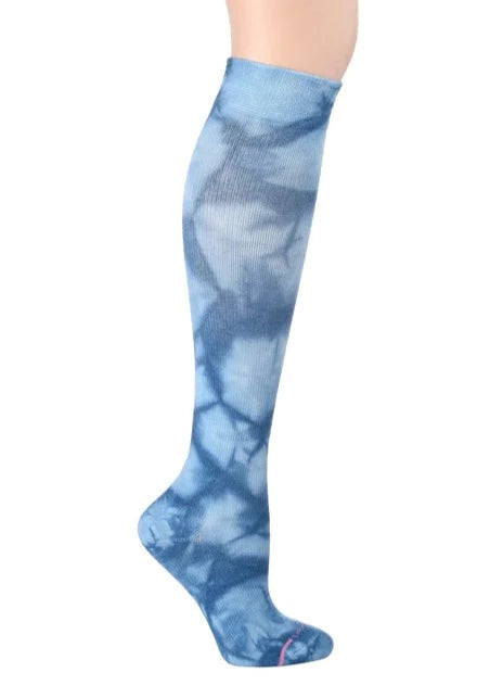 a blue and white tie dye knee high compression sock shown on a leg form