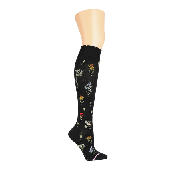 a knee high black sock printed with various sprigs of wildflowers
