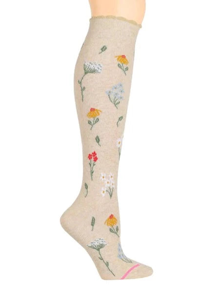a knee high light beige sock printed with various sprigs of wildflowers