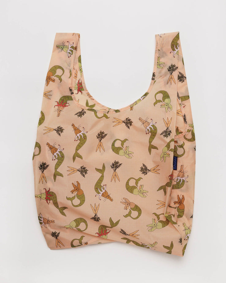 a light pink reusable shopping back with a print of illustrations of rabbit mermaids and small bunches of carrots