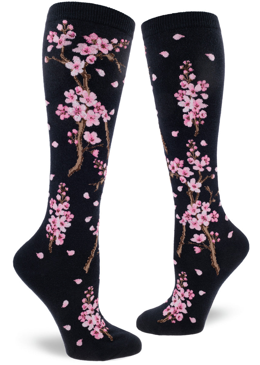 Knee-high socks with cherry blossom design on a dark navy background