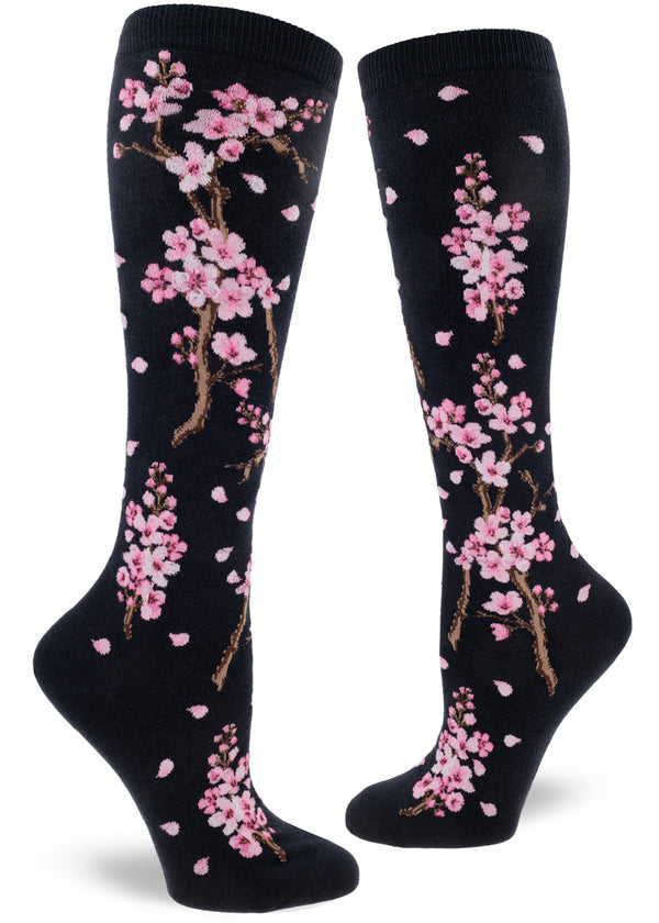 Knee-high socks with cherry blossom design on a dark navy background