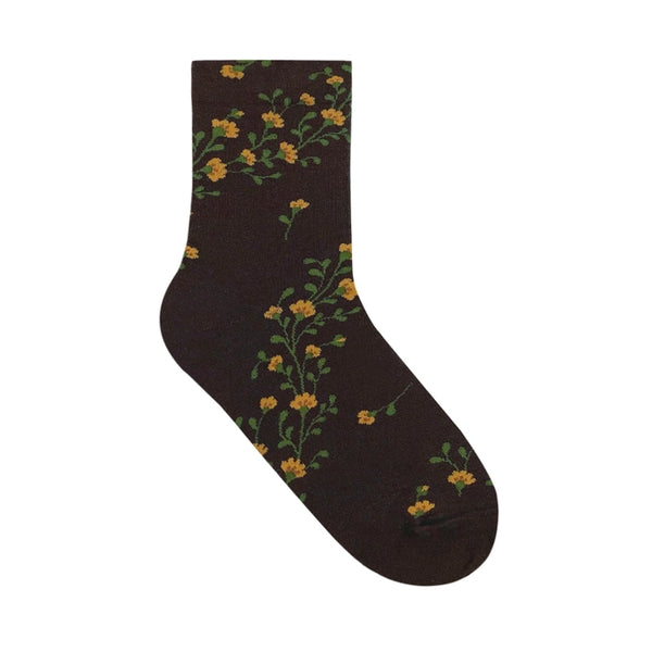 Brown sock with yellow flower design on white background