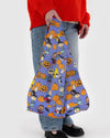 Person holding a colorful Halloween-themed bag with Peanuts characters and pumpkins.